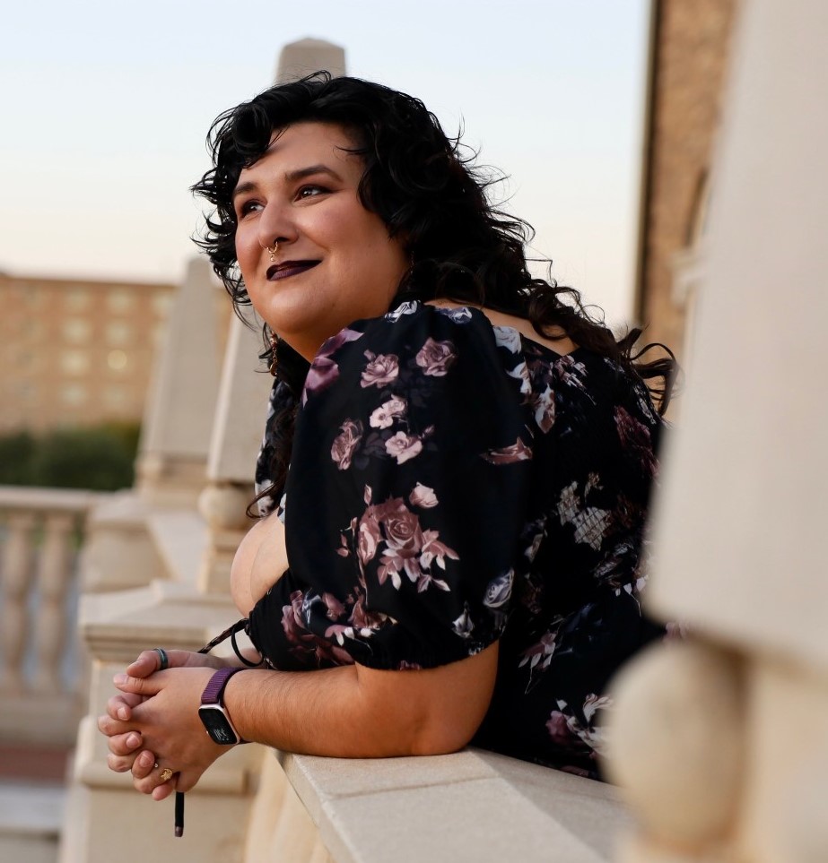 image of a woman facing away from camera with a background of buildings